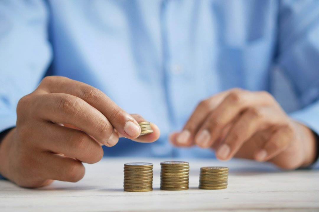 Men stacking coins